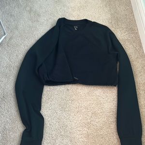 Never worn, but without tags, black cropped long sleeve shirt.